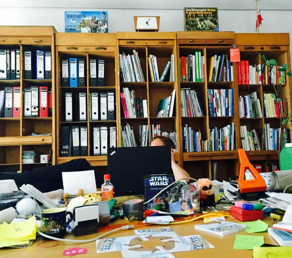 Schreibtisch vor vollen Bücherregalen